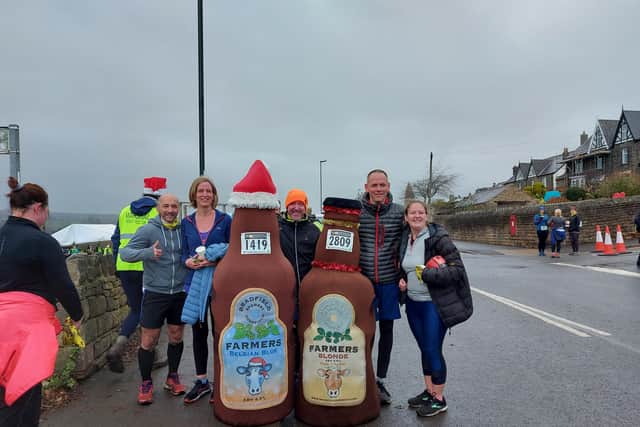 Two runners dressed as beer bottles take a moment to chill out roadside at the Percy Pud event. Picture by Andreea Popa
