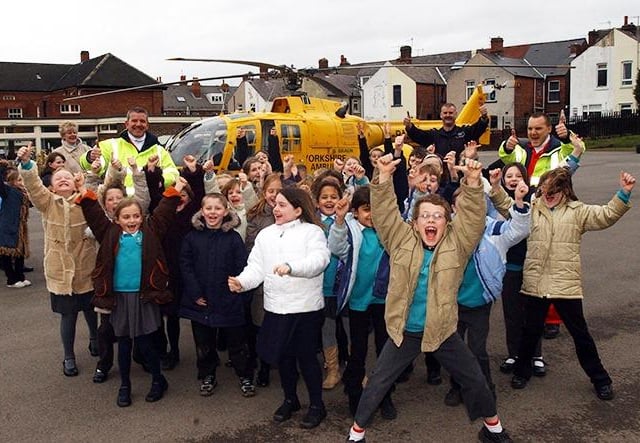 Pupils from Abbey Lane Primary School jump for joy as the Yorkshire Air Ambulance visits their school, on March 15, 2004