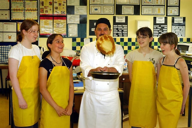 Birley Community college students got pancake tossing lessons as part of their French meal made for teachers, from Barry Cook, chef at Ardsley House Hotel, Barnsley, left to right, Sarah Gregg, Angela Orvice, Rachel Handisides and Mellisa Barrett, all aged 15 in 2003