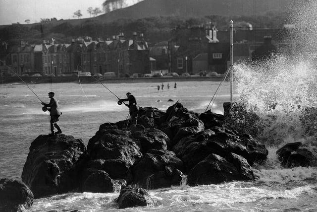 Two anglers battle for a shore prize at the North Berwick Angling Competition in October 1962.