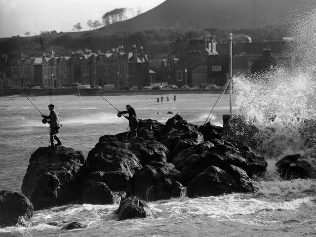 Two anglers battle for a shore prize at the North Berwick Angling Competition in October 1962.