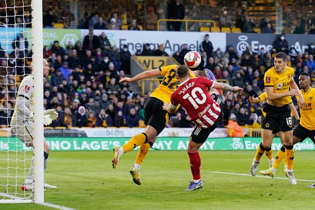 Wolves' Leandro Dendoncker appeared to duck his head to head the ball - but Sheffield United's goal was disallowed: Andrew Yates / Sportimage