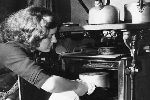 A housewife baking a cake in her oven.  (Photo by Keystone Features/Getty Images)