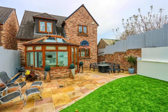 Astroturf and Indian sandstone paved patio are features of the rear garden.