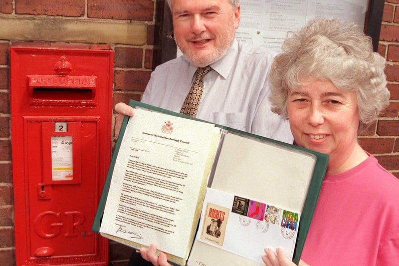Councillor John Dainty is pictured with his community diary entry and Finningley Post Office subpostmistress Mrs Bridget Clark in 1999