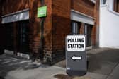 Signs for both a COVID-19 testing station and a polling station (Photo by Leon Neal/Getty Images)