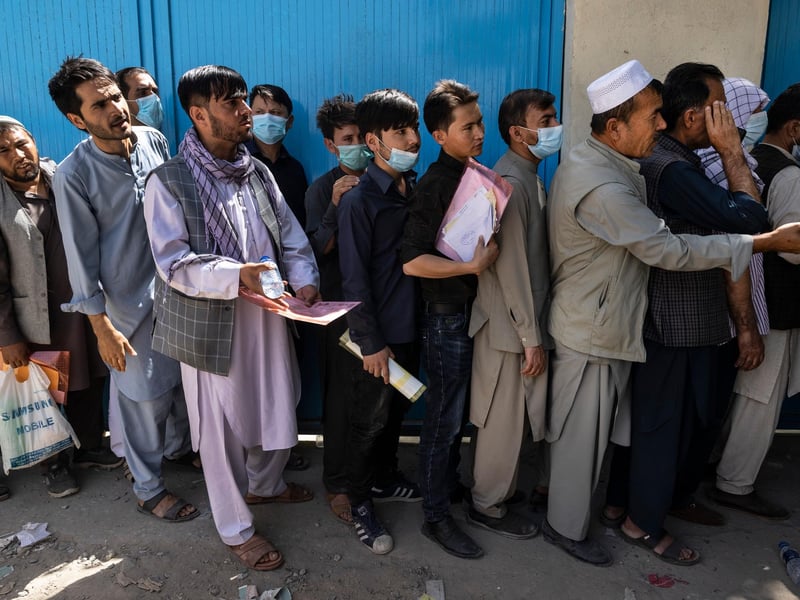 Afghans wait in long lines for hours at the passport office as many are desperate to have their travel documents ready to go