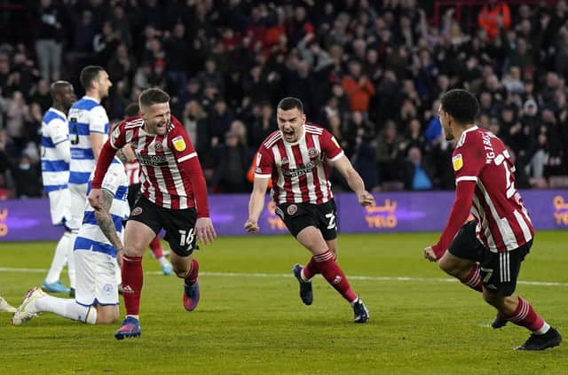 Ollie Norwood wheels away in celebration, followed by debutant Filip Uremovic, after scoring for Sheffield United against Queens Park Rangers: Andrew Yates / Sportimage