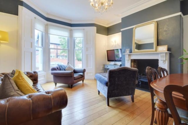 The large lounge at the front of the property features a bay window overlooking the garden and a period fireplace. Image by Peter Heron/ Zoopla.