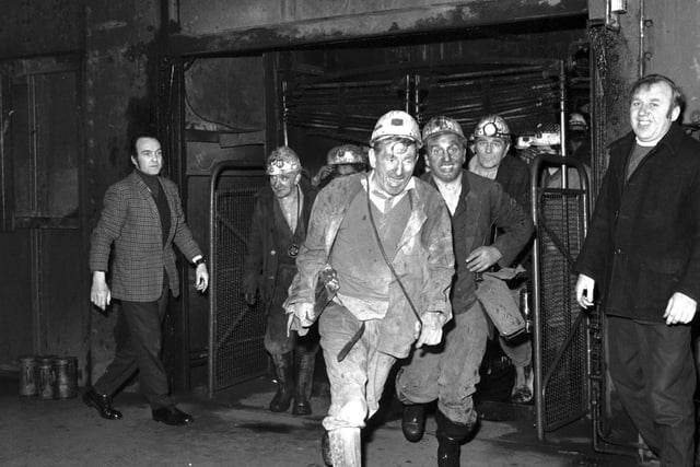 Miners at Monktonhall colliery leave the cage after their first shift back.