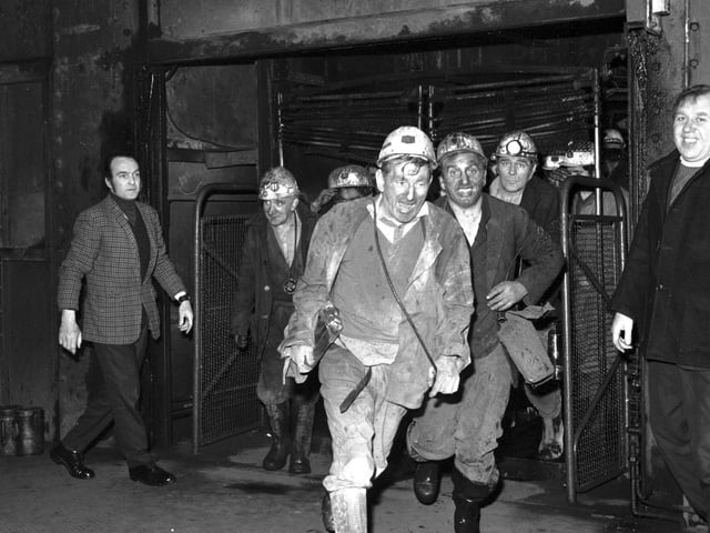 Miners at Monktonhall colliery leave the cage after their first shift back.