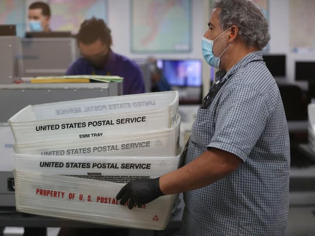 Workers at the Miami-Dade County Elections Department work on tabulating the Vote by Mail ballots that have been returned in Doral, Florida.