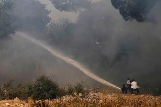 Volunteers battling devastating forest wildfires in northern Lebanon, where firefighters were struggling to protect homes from the blaze. Getty.