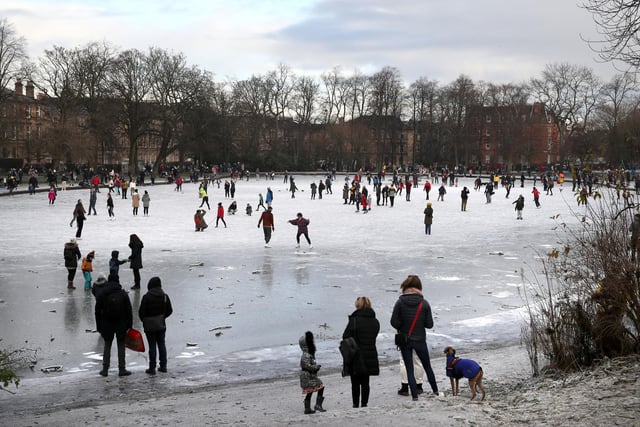 People walk on a frozen pond in Queen's Park in Glasgow. Picture: Andrew Milligan/PA Wire
