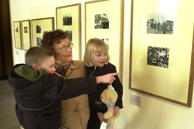 A show of spirit exibition of photographs from Sheffield showing celebration, remembrance and protest from 1850 to the present day, at the City Museum,  the 1984 miners strike is viewed here by Barbara Wyld from Eckington with her grandchildren Calum Kerr, 6 and Emily Kerr, 4 in February 2001.