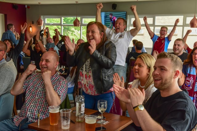 South Shields football fans celebrate while watching the club's 2017 FA Vase victory at Wembley on television.