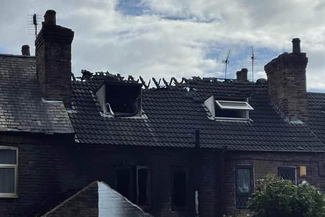 A rear view of the damage the fire did to the family home's roof