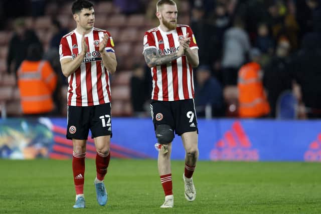 Sheffield United duo John Egan and Oli McBurnie (right) applaud the fans at Bramall Lane: Richard Sellers / Sportimage
