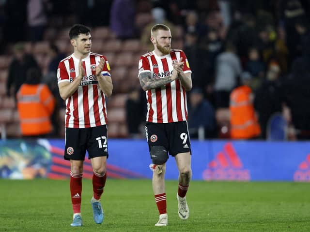 Sheffield United duo John Egan and Oli McBurnie (right) applaud the fans at Bramall Lane: Richard Sellers / Sportimage