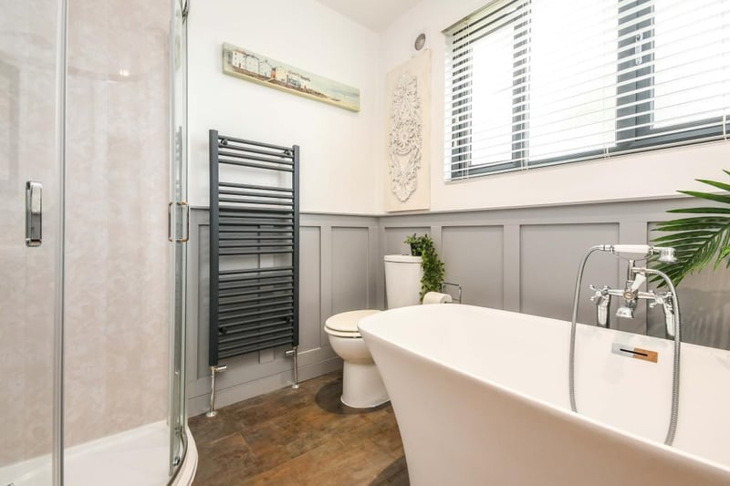 The bathroom has a beautiful, double-ended bath with a mixer tap and shower attachment, single shower enclosure, low-flush WC and a vanity sink with a mixer tap.