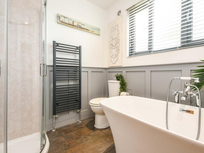 The bathroom has a beautiful, double-ended bath with a mixer tap and shower attachment, single shower enclosure, low-flush WC and a vanity sink with a mixer tap.