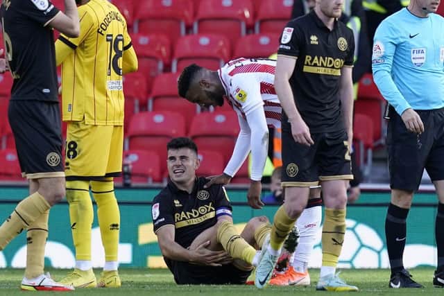 Skipper John Egan gave Sheffield United another injury scare at Stoke City this afternoon: Andrew Yates / Sportimage