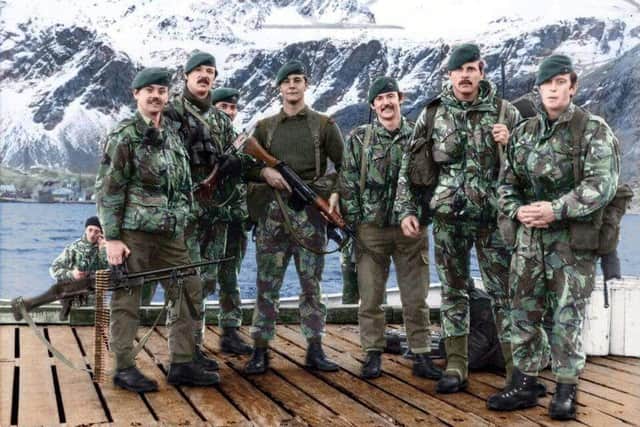 Ian Tennant, pictured in the centre in the green woollen jumper, on a pontoon on South Georgia having been part of the operation to liberate the island from Argentine invaders in 1982