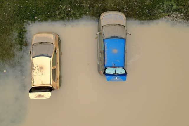 Water damaged cars are seen as flood waters begin to recede in the village of Catcliffe after Storm Babet flooded homes, business and roads. PIC: Christopher Furlong/Getty Images