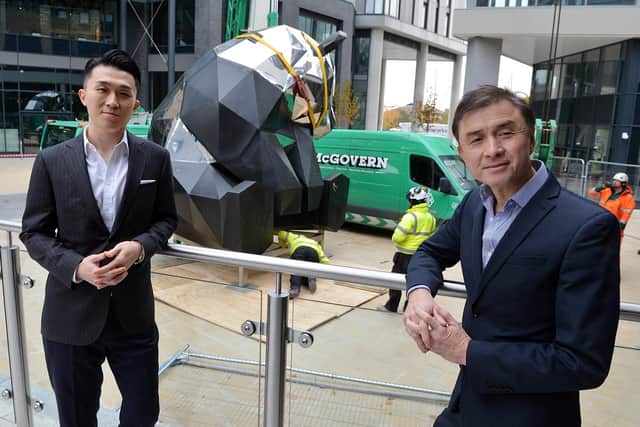 Rongmin Qin, executive director, and Jerry Cheung, managing director of New Era development UK, with the panda sculpture