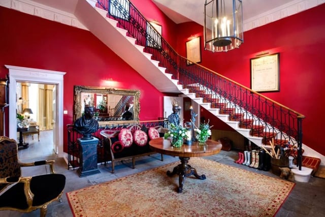 The entrance hall in this four story home features a wrap-around sweeping staircase and the subsequent landings feature fireplaces and marble pillars, with one aptly called the Queens landing, for its regal charm.