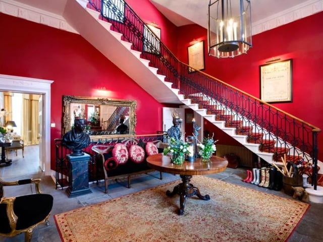 The entrance hall in this four story home features a wrap-around sweeping staircase and the subsequent landings feature fireplaces and marble pillars, with one aptly called the Queens landing, for its regal charm.