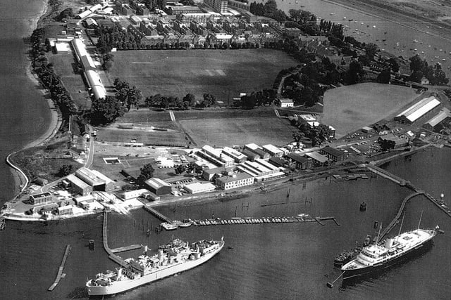 HMS Excellent on Whale Island aerial view 1970.
Bottom right at her mooring is the Royal Yacht Britannia where she was always located when not in use. The grey ship to the left is HMS Rame Head that was a Canadian ship. She was a training ship later followed by HMS Bristol which still uses the birth to this day. Just above the playing field are the barrack blocks.