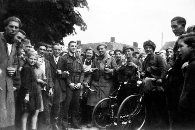The air crews join in liberation celebrations in September 1944 in Belgium with villagers and arriving troops