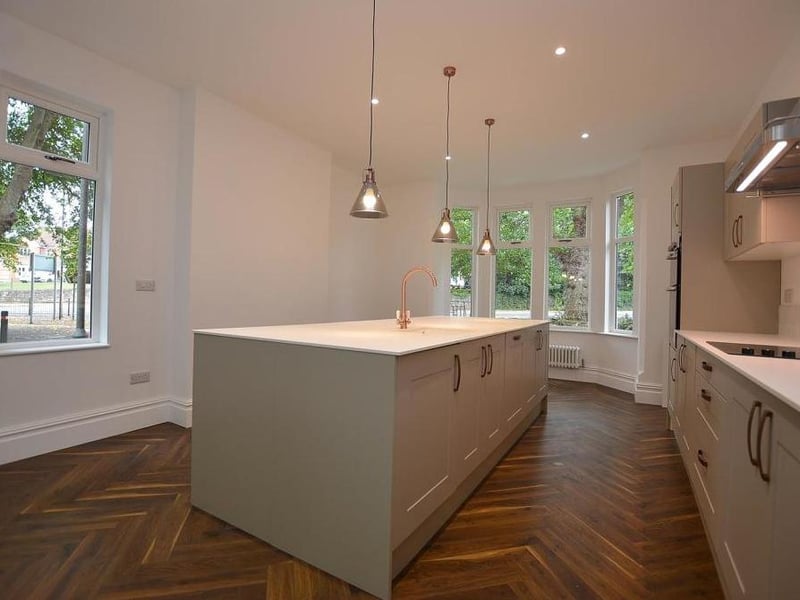 Another view of the kitchen, which also boasts a free-standing, American fridge freezer. Other features include an integrated dishwasher, ceiling spotlights, parquet flooring and dual-aspect, double-glazed windows.