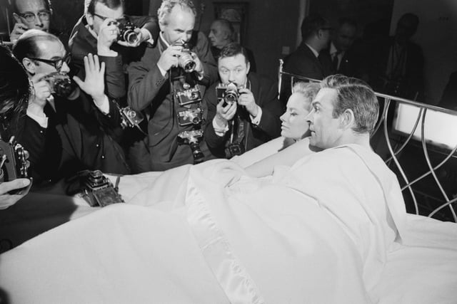 Sean Connery and Luciana Paluzzi being photographed in bed on the set of the James Bond film, 'Thunderball', 8th March 1965.