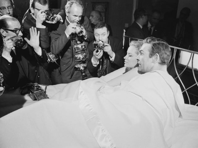Sean Connery and Luciana Paluzzi being photographed in bed on the set of the James Bond film, 'Thunderball', 8th March 1965.