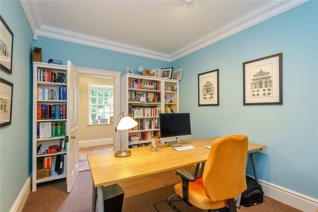 The home office is bright and airy, with plenty of space for working and has ample room for storage.