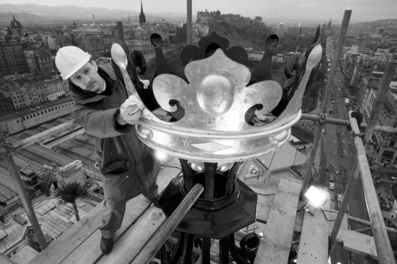Project manager Ronnie Doig replaces the cleaned and burnished 'crown' from the very top of the North British hotel (NB hotel/Balmoral hotel) in Princes Street Edinburgh, December 1989. 