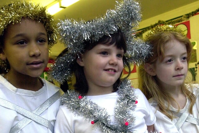 Angels, l/r: Jaydeen Griffiths(7), Holly Fearn and Charley Horner(both 6) in the Christmas Infant Nativity at Walkley Primary School,  December 2003