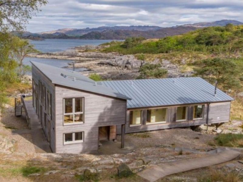 The house is surrounded by whispering pine trees, mountains and glens.