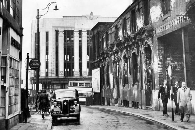 Change Alley, Sheffield, which ran from High Street to Norfolk Street, pictured soon after the Second World War, showing the scars of the 1940 Blitz.  In the background is the shell of the shattered Burton's building at the corner of Angel Street and High Street, Circa 1950