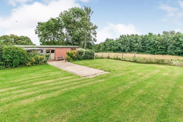 Another look outside, which gives you an idea of the vast green space and also the outbuildings that are part of the property. All surrounded by trees, bushes and hedgerows.