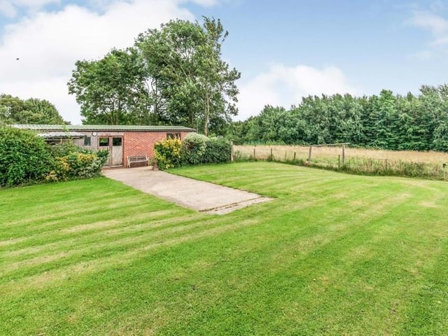 Another look outside, which gives you an idea of the vast green space and also the outbuildings that are part of the property. All surrounded by trees, bushes and hedgerows.