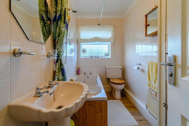 The family bathroom consists of a panelled bath with shower over, a pedestal wash hand basin and low-flush WC. A laminate floor, tiled walls and coving to the ceiling complete the look, while an airing cupboard houses the hot-water cylinder.