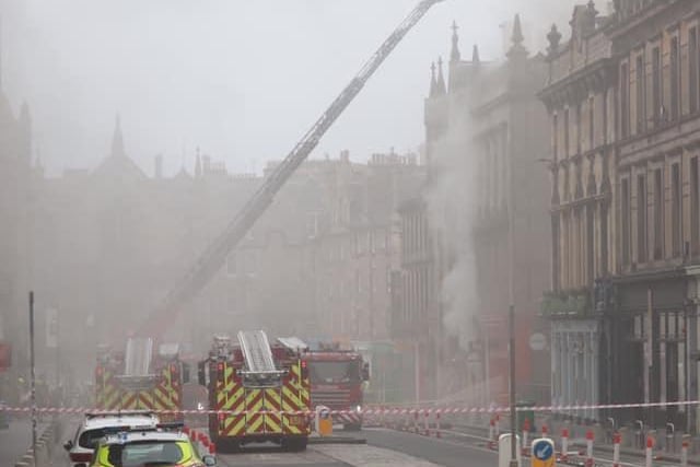 Smoke billows out from the affected buildings.