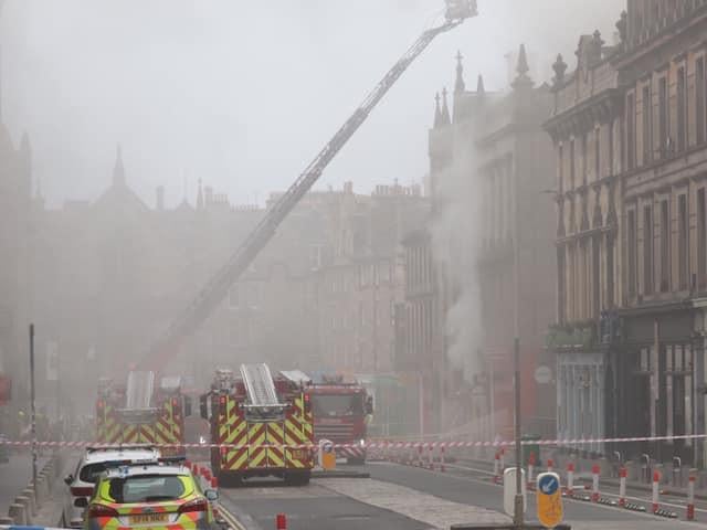 Smoke billows out from the affected buildings.