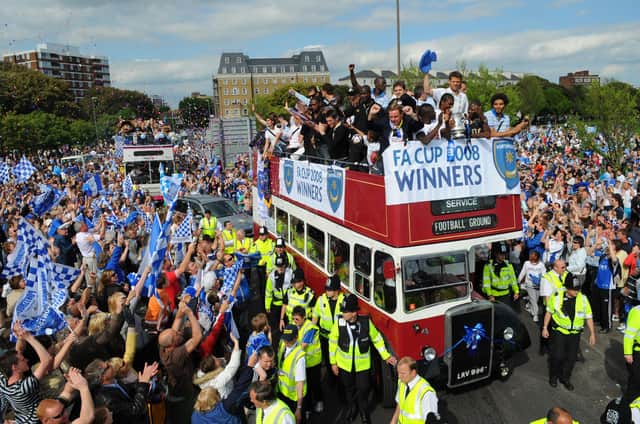 Fans celebrate with the players at the FA Cup Pompey parade. Picture: Malcolm Wells 082235-5585