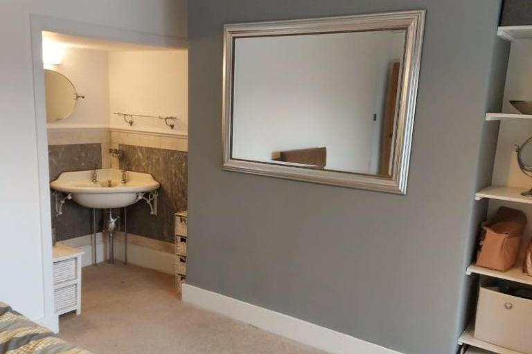 To one wall there are built-in wardrobe facilities with cupboard space above. To the corner of the bedroom there is a period hand wash basin with marble surround.