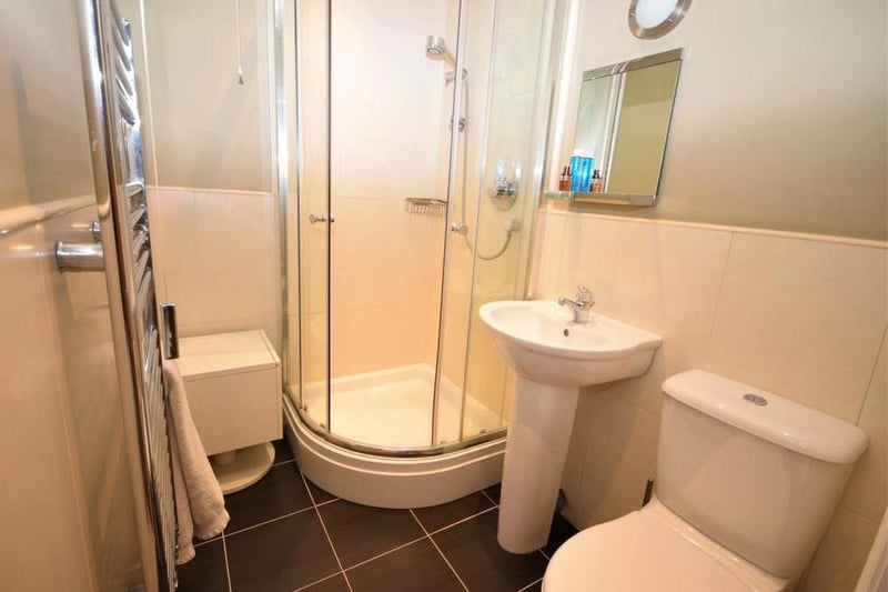 The en suite facilities for the second bedroom. There is a shower cubicle, low-flush WC, wash basin and central-heated towel-rail.