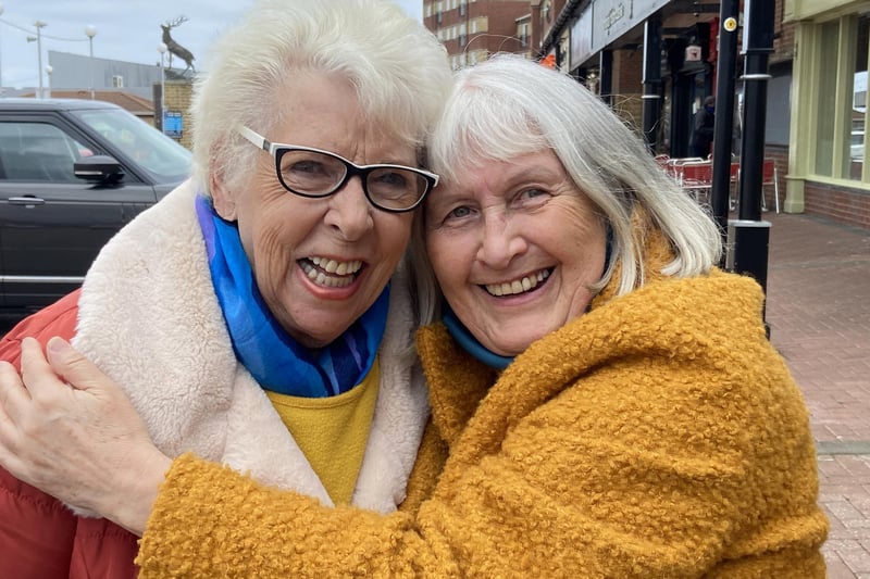 Friends Pat Edgar, left, and friend Pauline hug on reopening day.